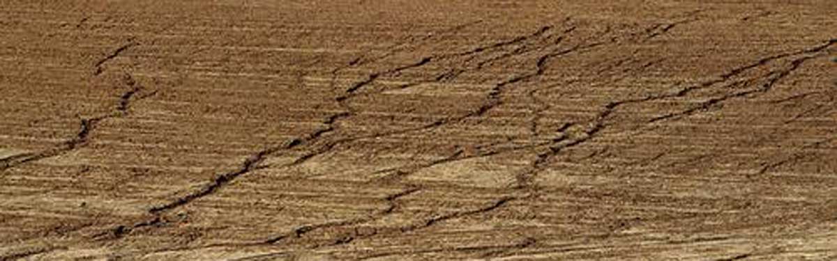 Sheet erosion occurs when water flows over a uniform slope and removes the top layer of soil.